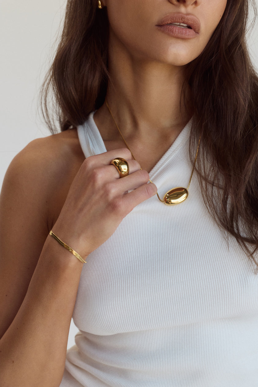 Cendré Beau Snake gold bracelet styled with stacked jewellery
