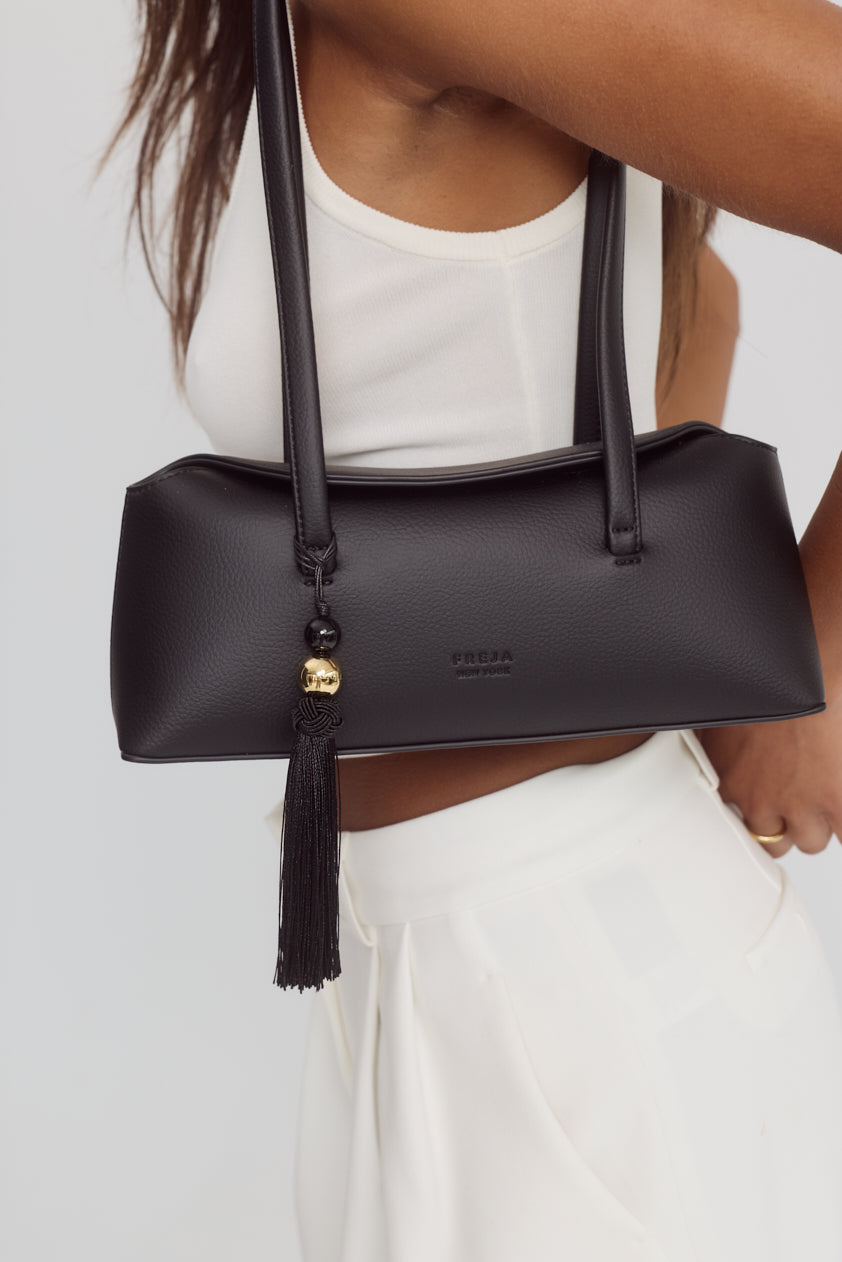 Cendré Lucetta bag charm styled on a handbag