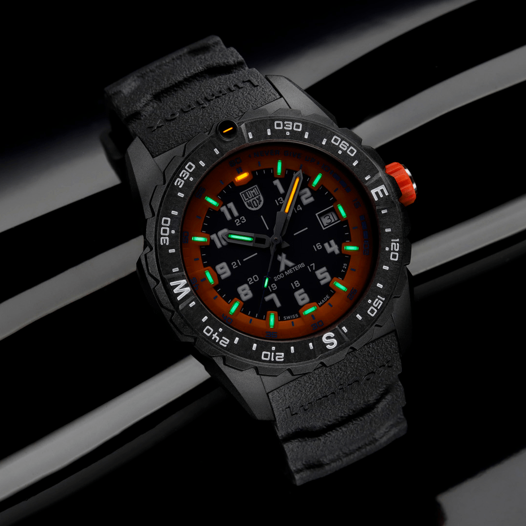 Rugged black wristwatch with colorful illuminated dial and orange accents.