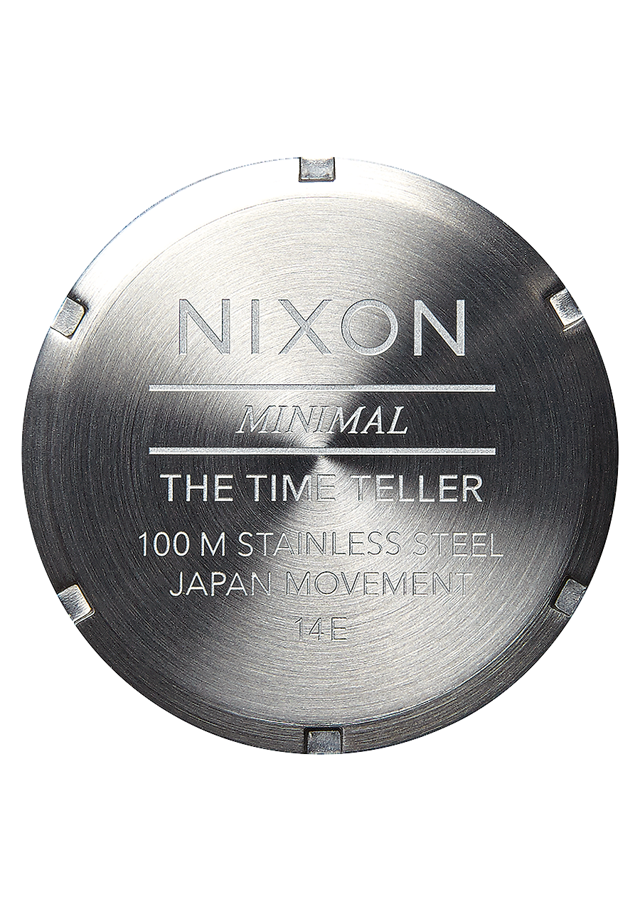 Stainless steel watch case back engraved with ’Nixon’ and product details.