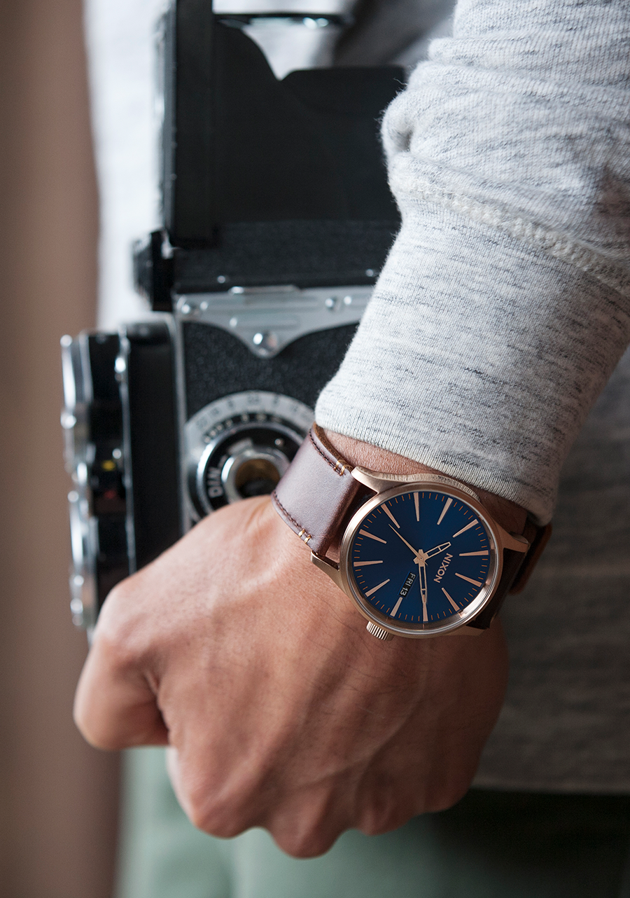 Elegant wristwatch with a blue dial and brown leather strap.