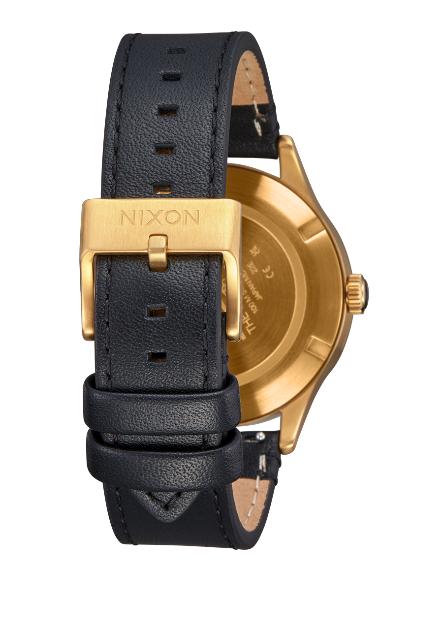 Wristwatch with a black leather strap and gold-toned case.