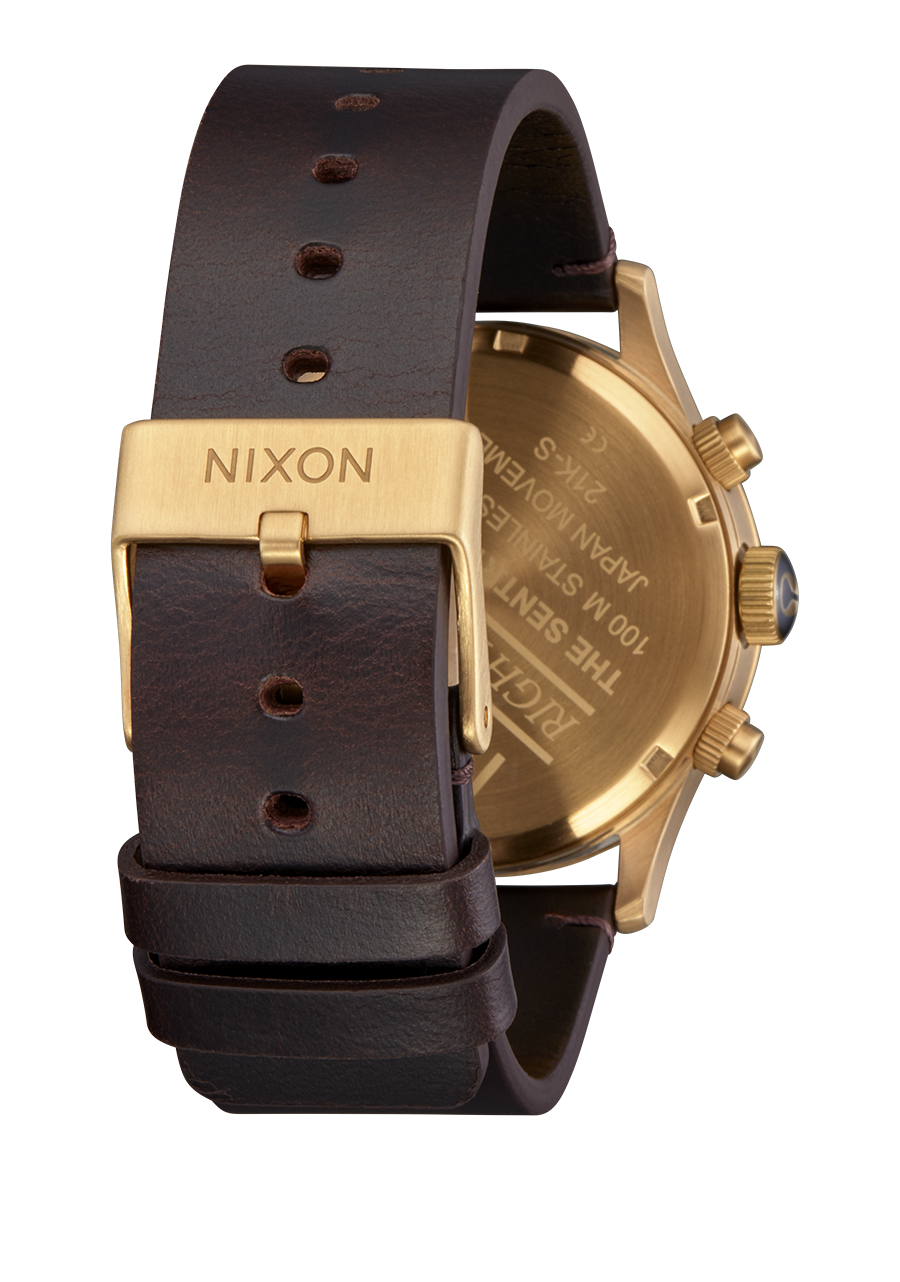 Wristwatch with a gold-toned case and brown leather strap.