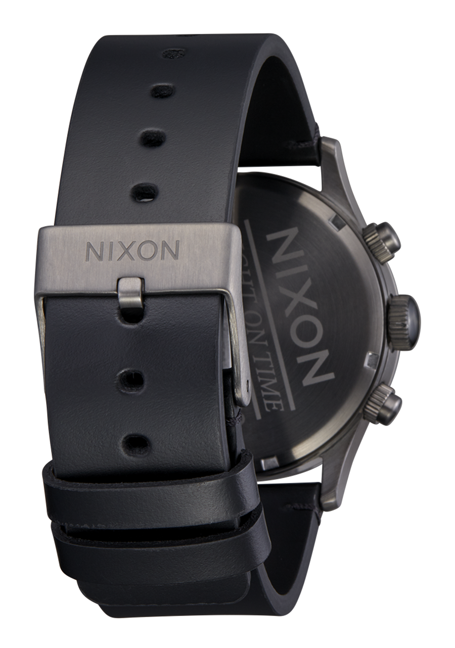 Black wristwatch with a Nixon-branded buckle and case back.