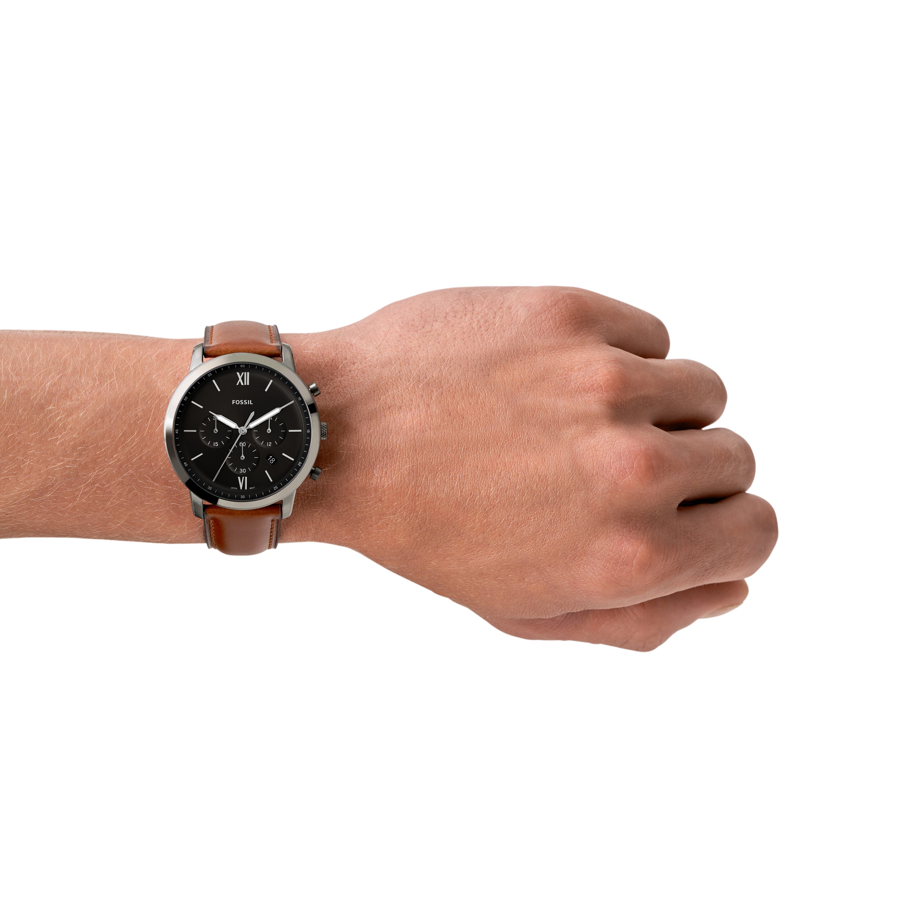 Wristwatch with a black face and brown leather strap worn on a person’s wrist.