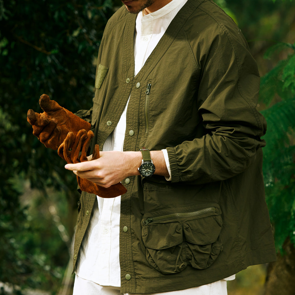 Close-up of the Seiko HDB008K khaki green dial with luminous numerals and compass bezel.