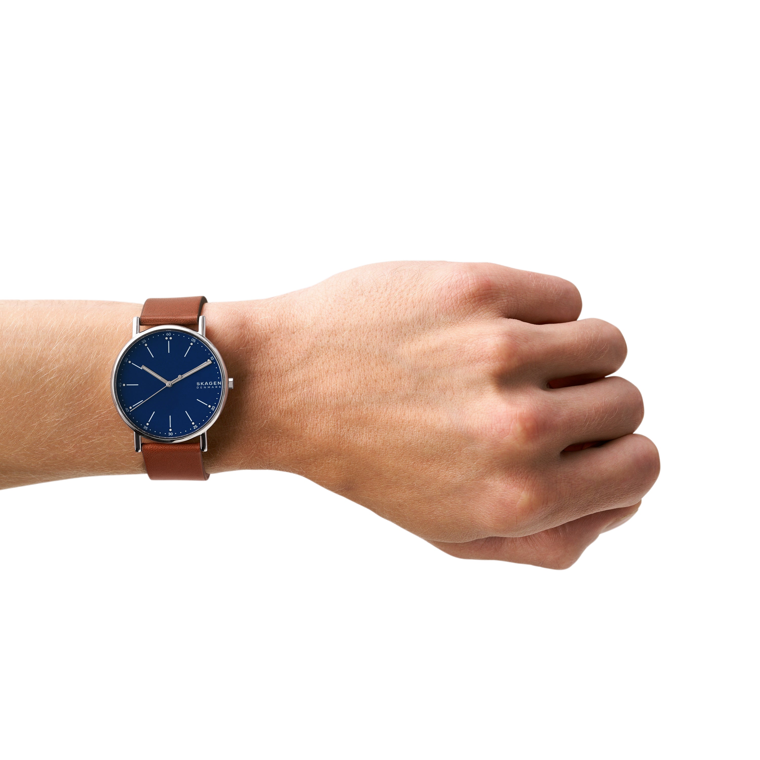 Wristwatch with a blue face and brown leather strap worn on a person’s wrist.