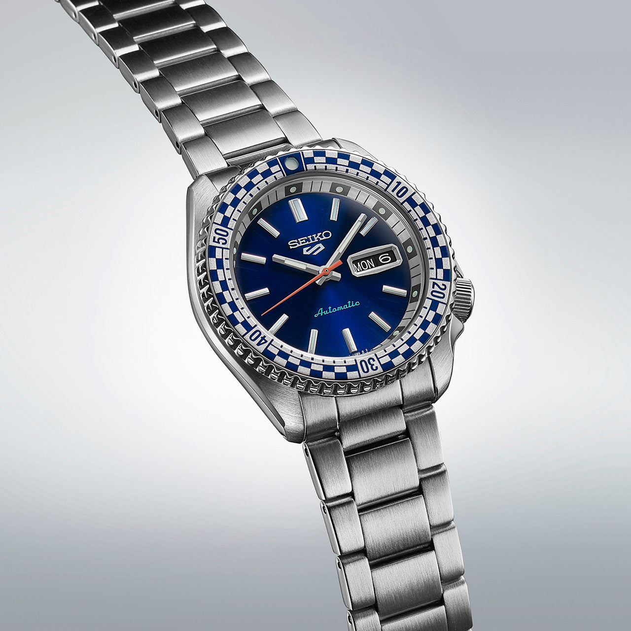 Stainless steel wristwatch with a blue dial and gemstone-encrusted bezel.