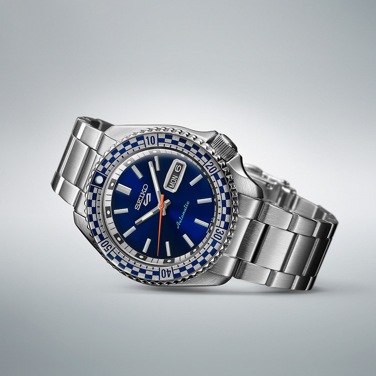 Stainless steel wristwatch with a blue dial and gemstone-encrusted bezel.