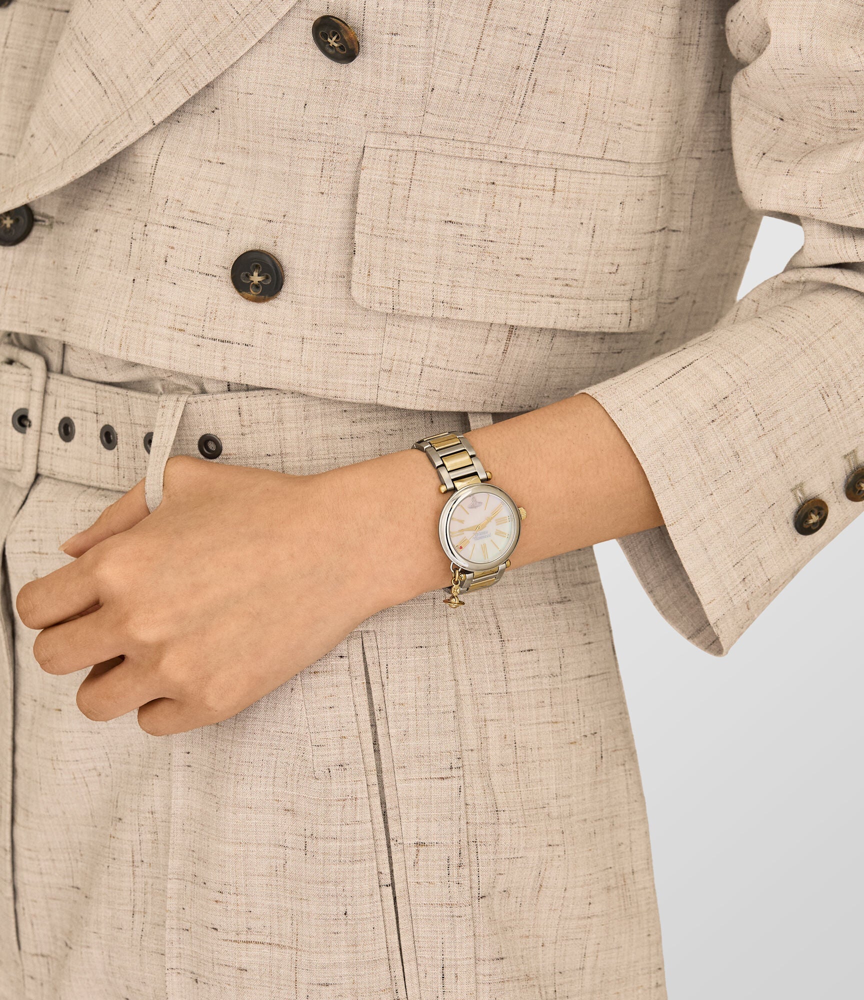Vivienne Westwood Mother Orb women's watch with a mother of pearl dial and two tone stainless steel bracelet. Close-up detail view.