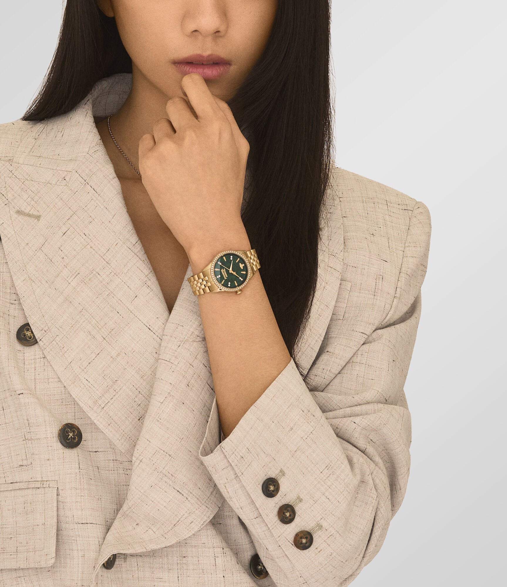 Vivienne Westwood Little Wallace women's watch with a green dial and gold stainless steel bracelet. Close-up detail view.