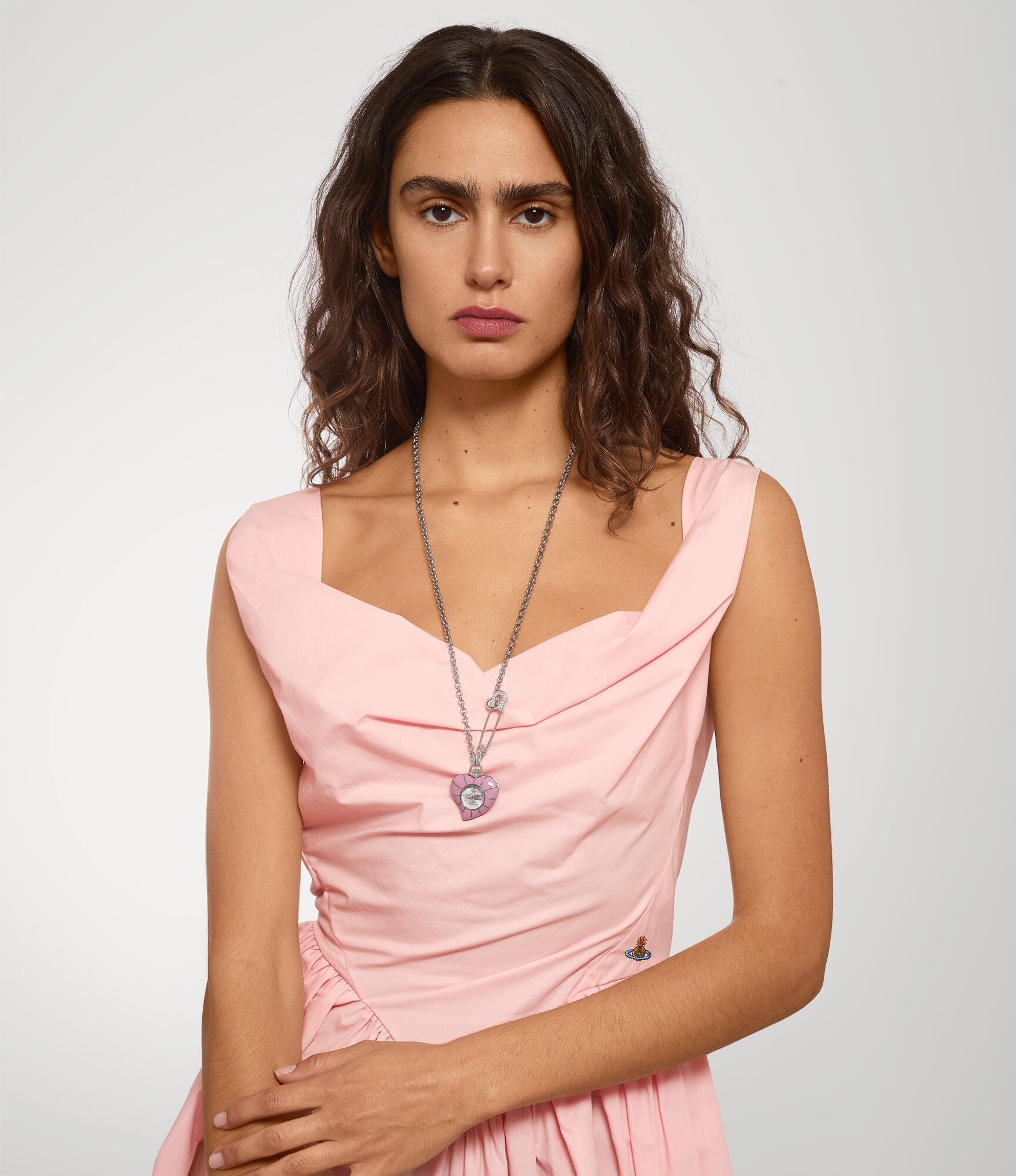 Vivienne Westwood Heart Pendant women's watch with a silver dial and silver pendant chain. Shown at an angle.