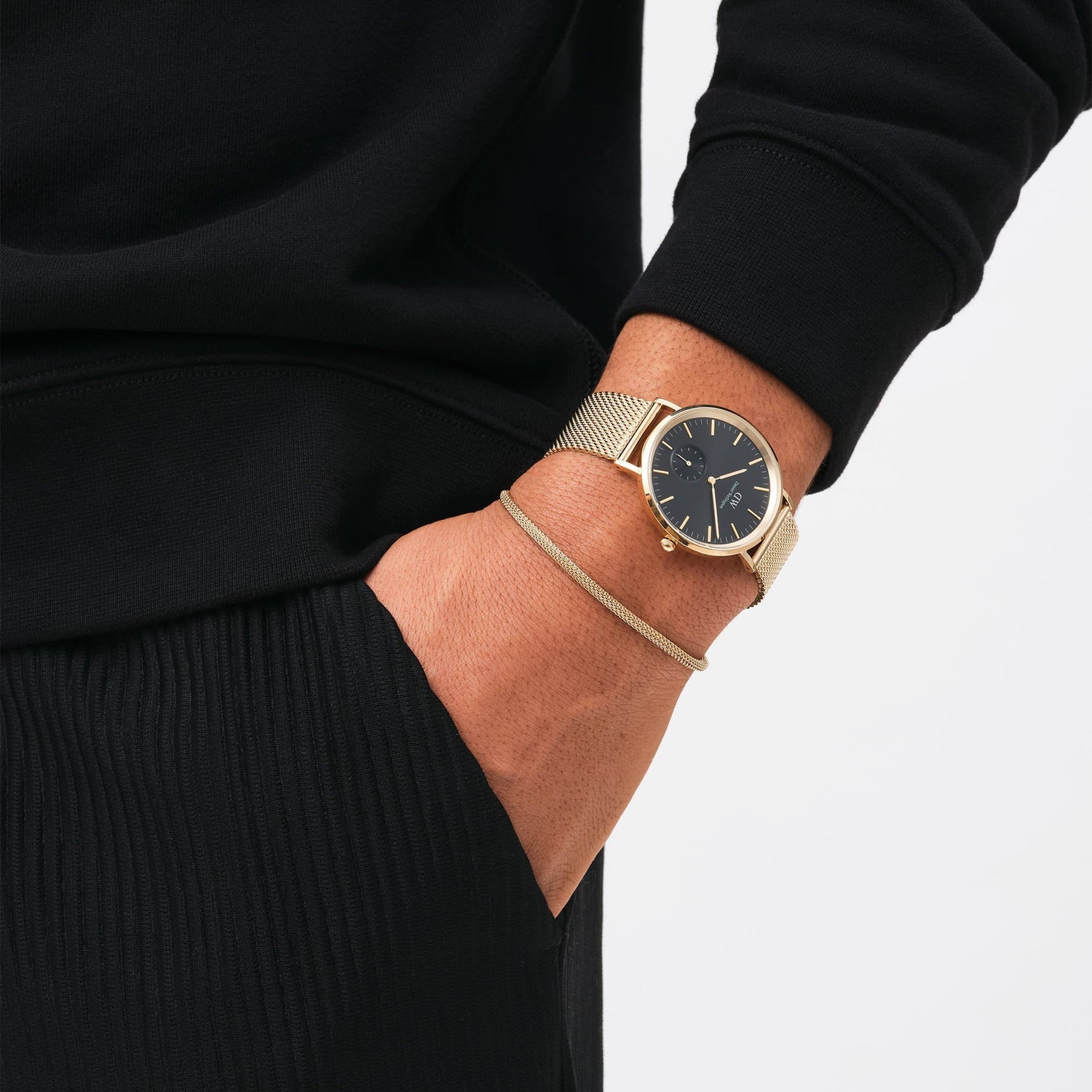 Elegant wristwatch with a black dial and gold-tone metal band.