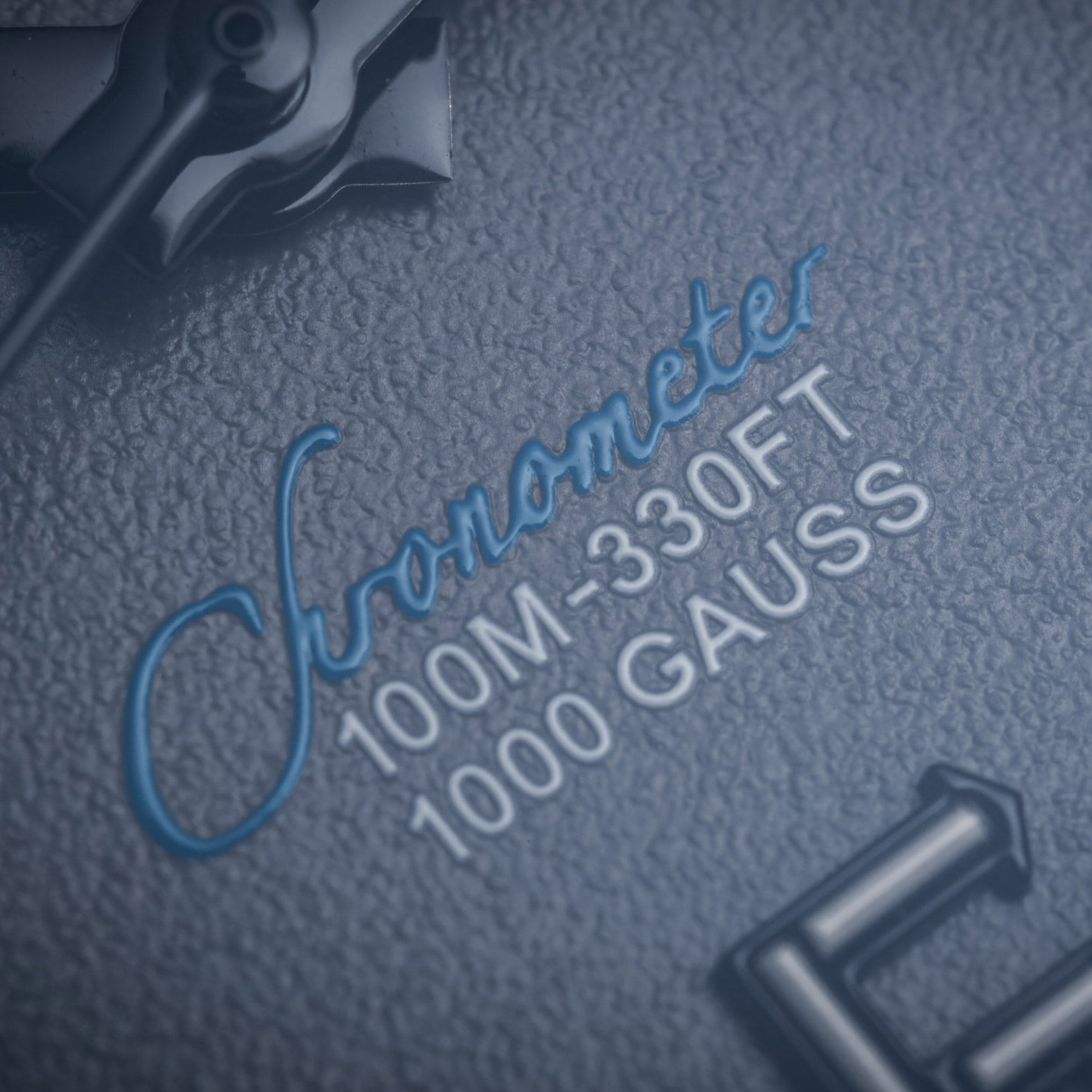 Text on a textured surface with 'Chronometer' and technical specifications.