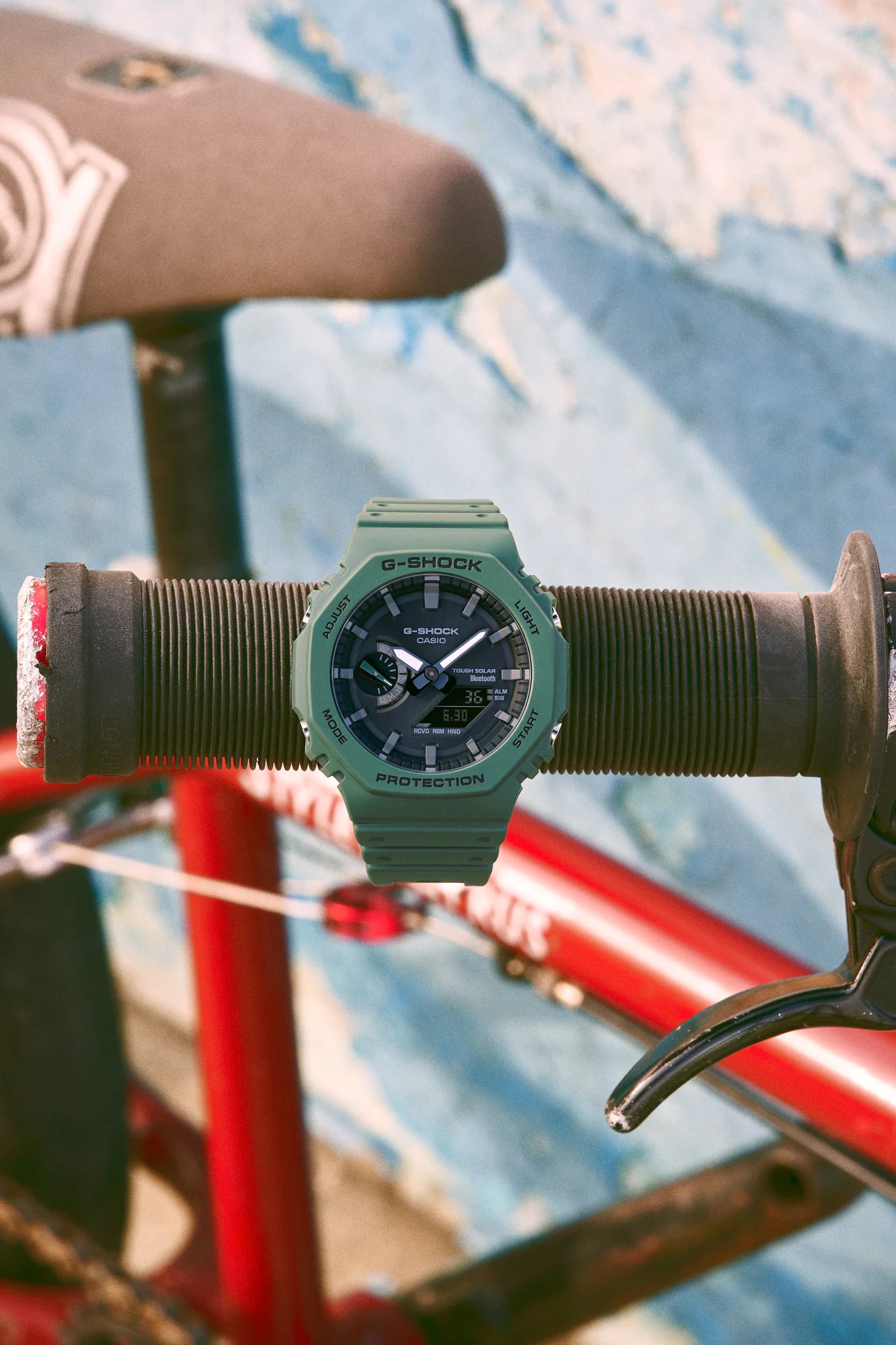 Green analog-digital wristwatch with a sporty design.