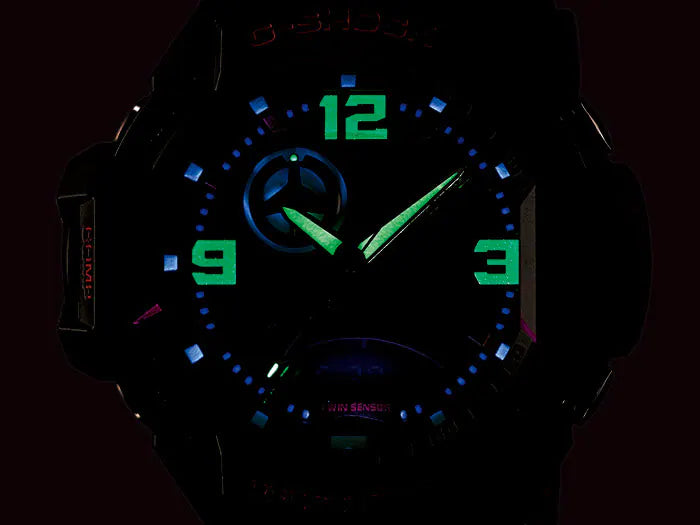 Illuminated analog watch face with glowing green and blue numbers and hands.