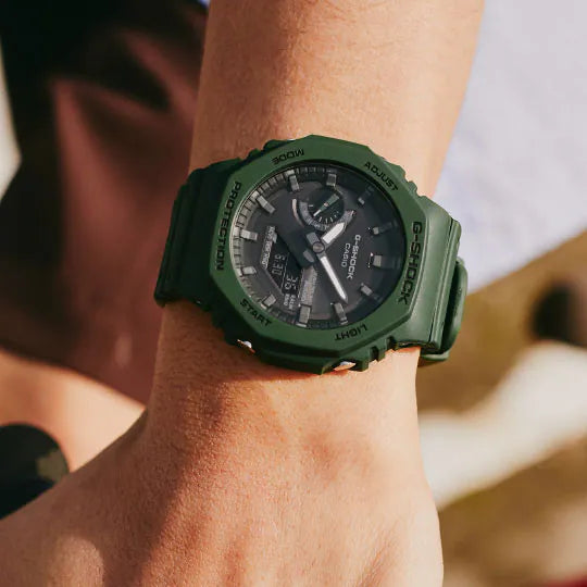 Green rugged digital wristwatch with a round face and multiple display features.
