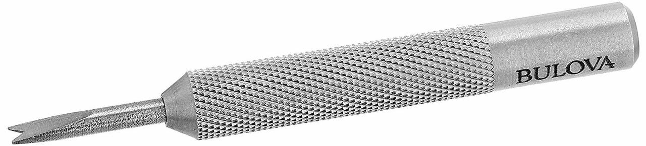 Metallic watch band adjustment tool with a textured grip and pointed tip.