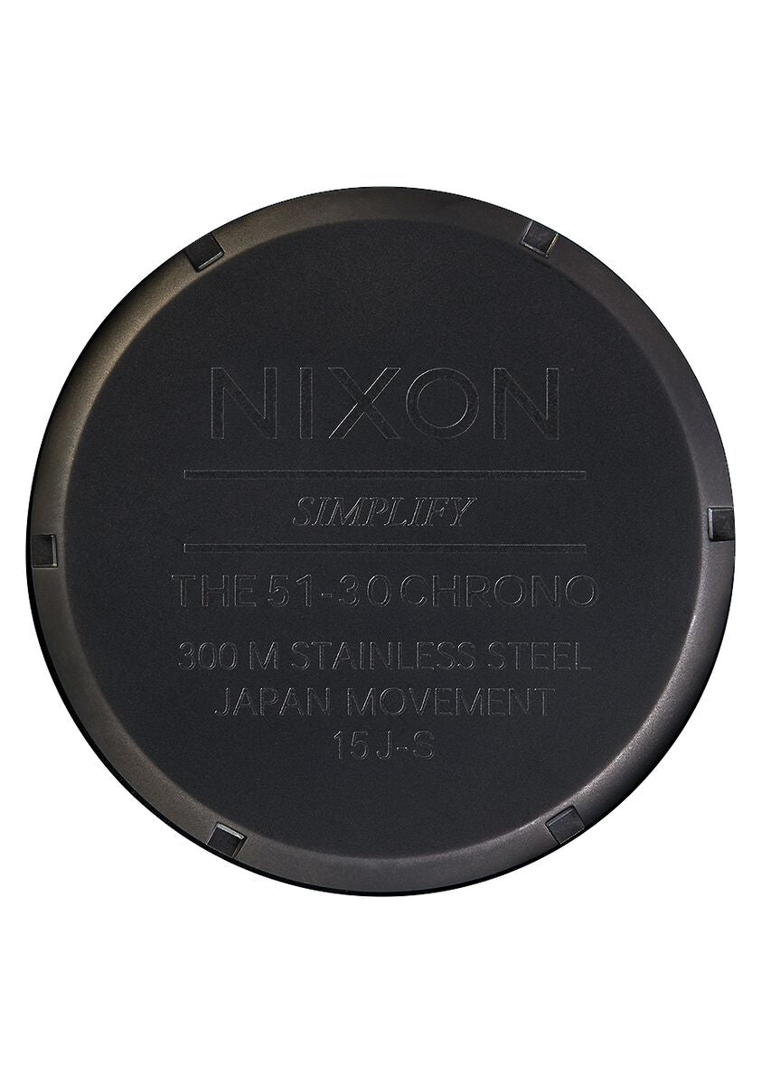 Circular black watch case back with engraved text.