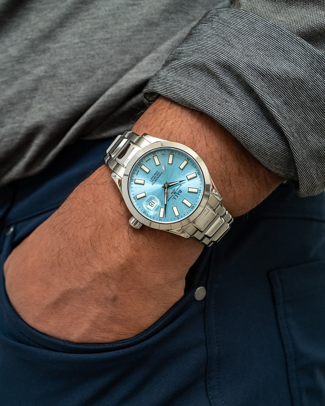 Wristwatch with a light blue dial and silver metal bracelet.