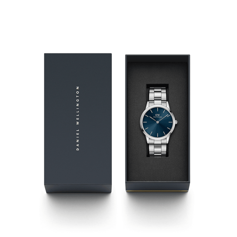 Wristwatch with a blue dial and silver metal bracelet in a presentation box.