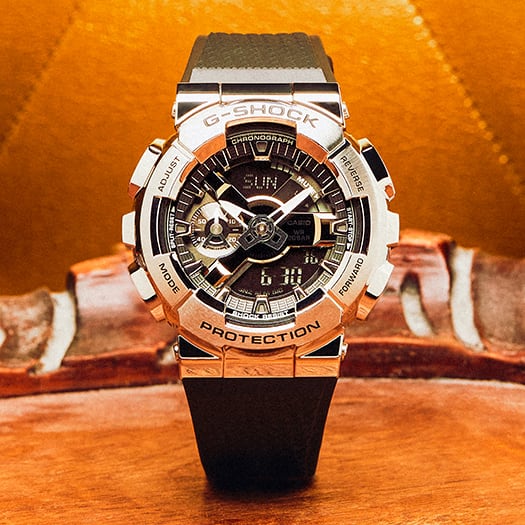 G-Shock wristwatch with a silver and black color scheme, featuring a complex digital-analog display and a black strap.