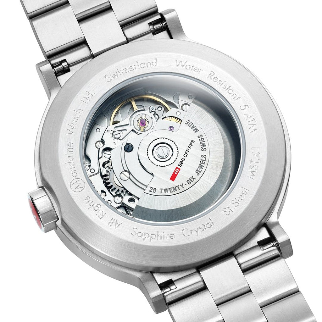 Back of a luxury wristwatch with a transparent case showing the internal mechanism.