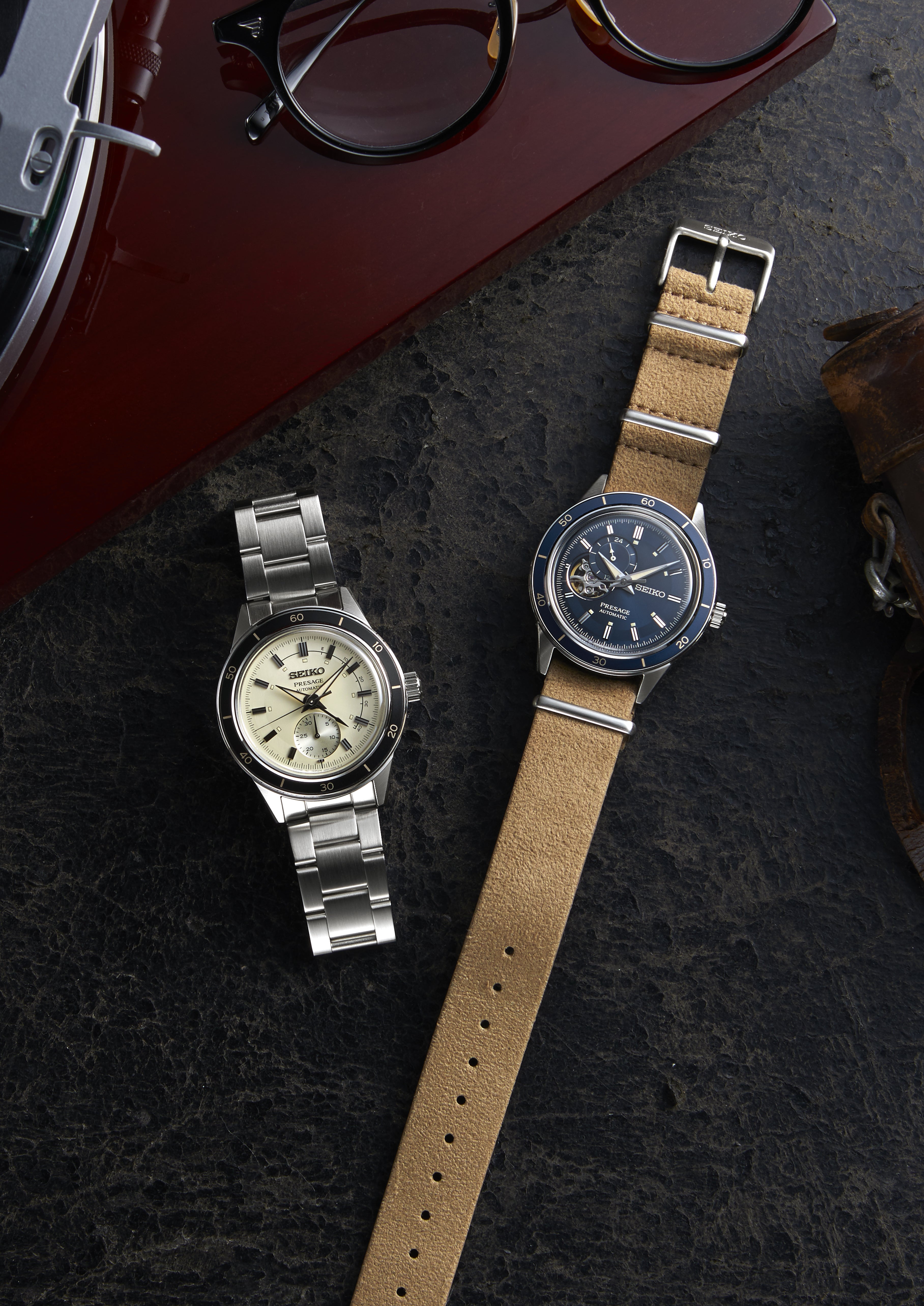 Two wristwatches with different styles of bands and faces.