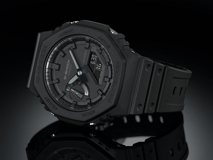 Black analog wristwatch with a round face and rubber strap.