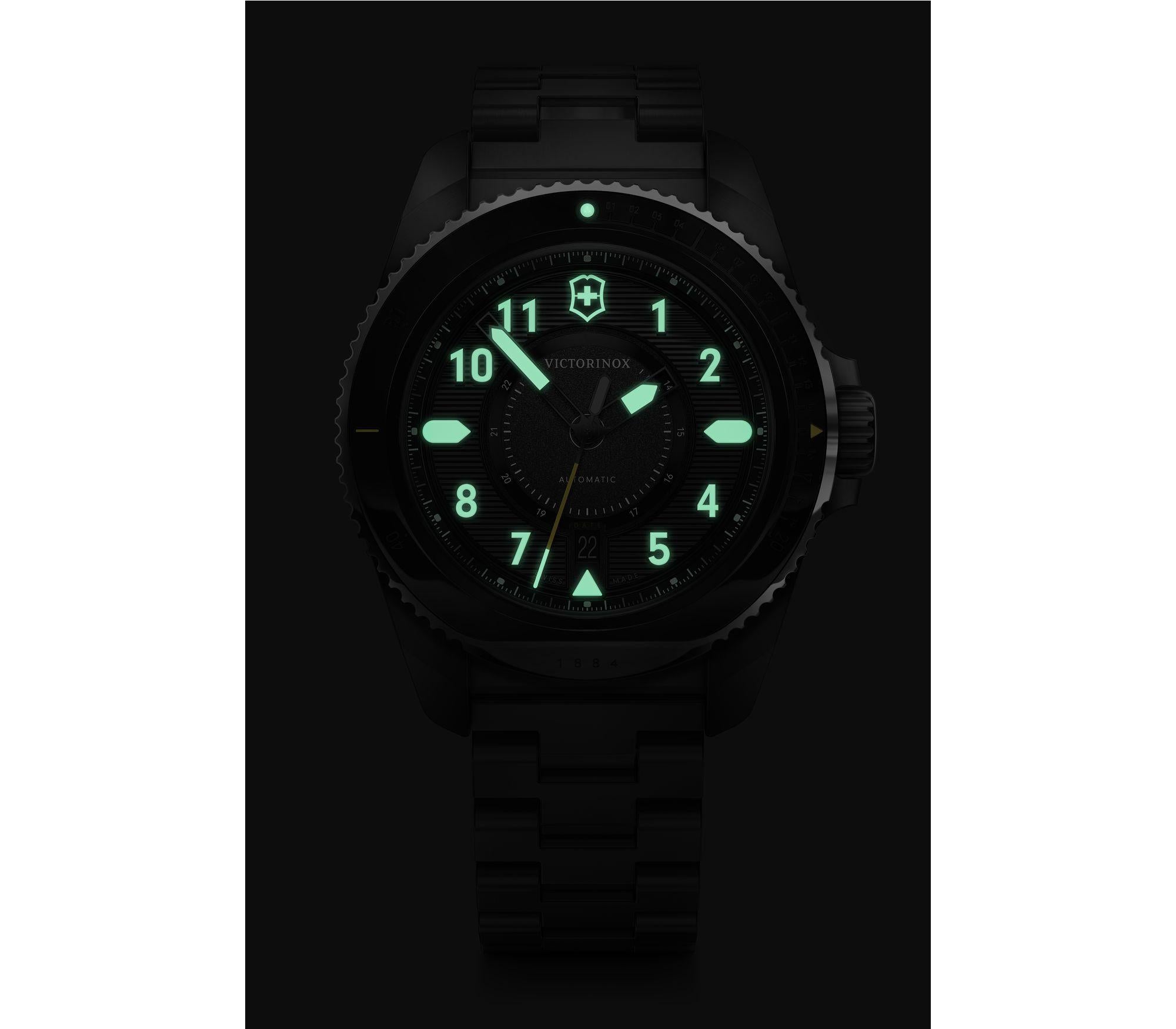 Luminous analog watch face with glowing green numbers and markings against a dark background.
