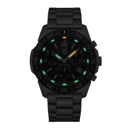 Black wristwatch with illuminated green and yellow markers on the dial.