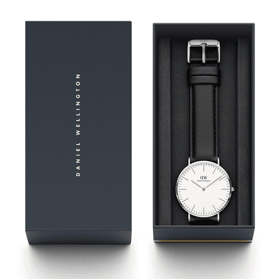 Elegant wristwatch with a white face and black leather strap in a presentation box.