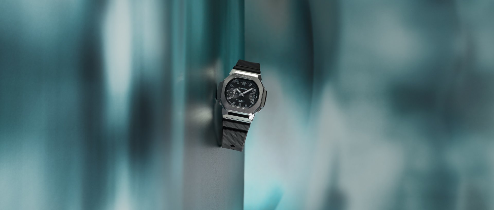G-SHOCK GMC2500-1A analogue watch on a teal key visual background