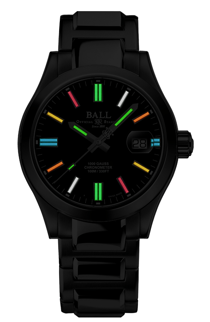 Ball NM9016C-S5C-BKR at night with 19 rainbow micro gas tubes glowing on the hands and dial
