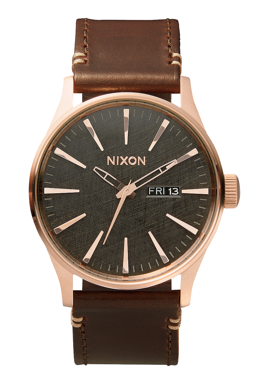 Wristwatch with a rose gold case, dark green dial, and brown leather strap.