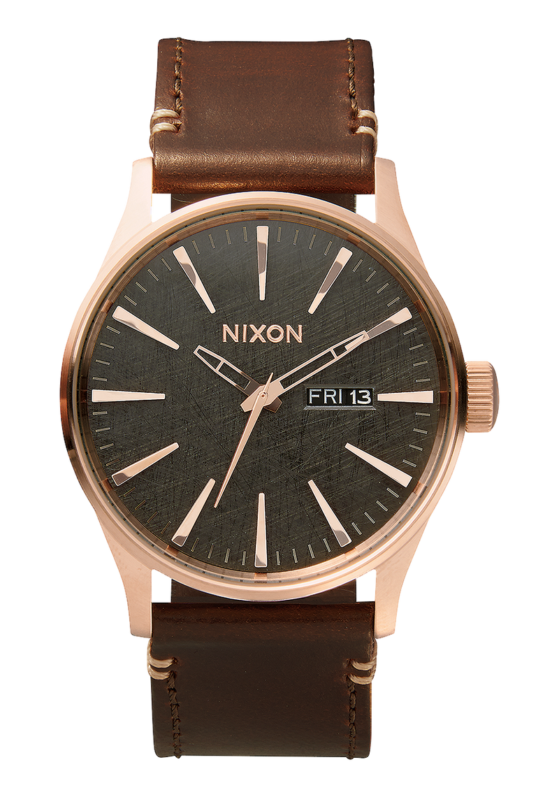 Wristwatch with a rose gold case, dark green dial, and brown leather strap.