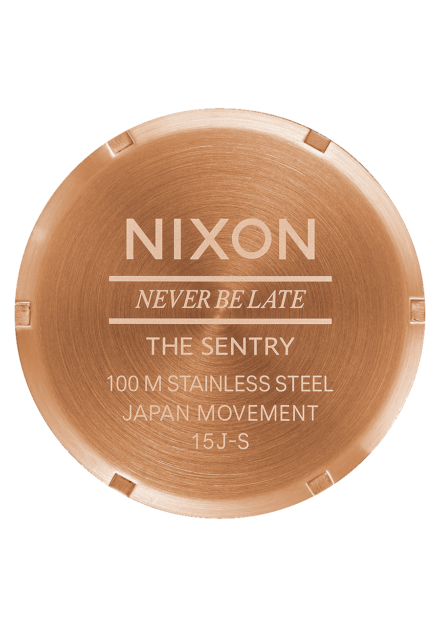 Circular watch case back engraved with ’Nixon’ and product details.