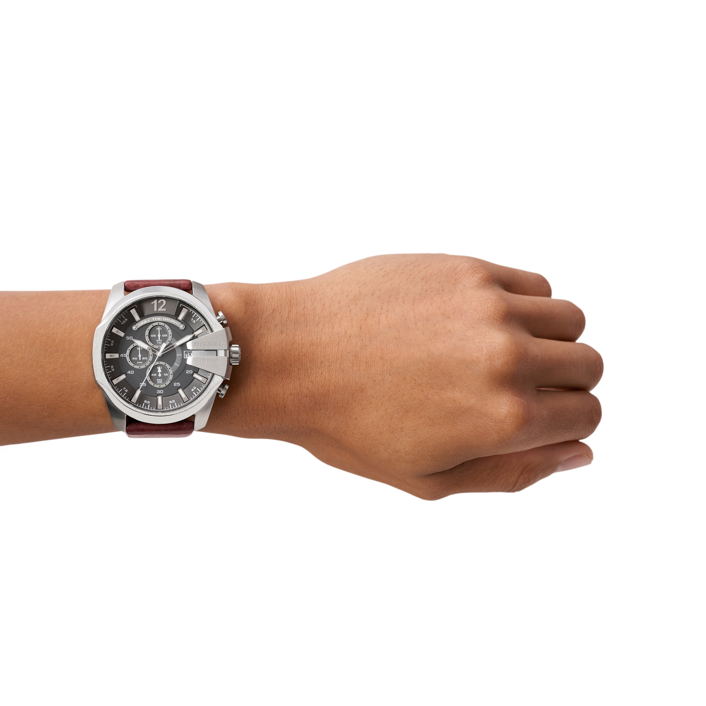 Wristwatch with a brown leather strap and silver-toned case on a person’s wrist.