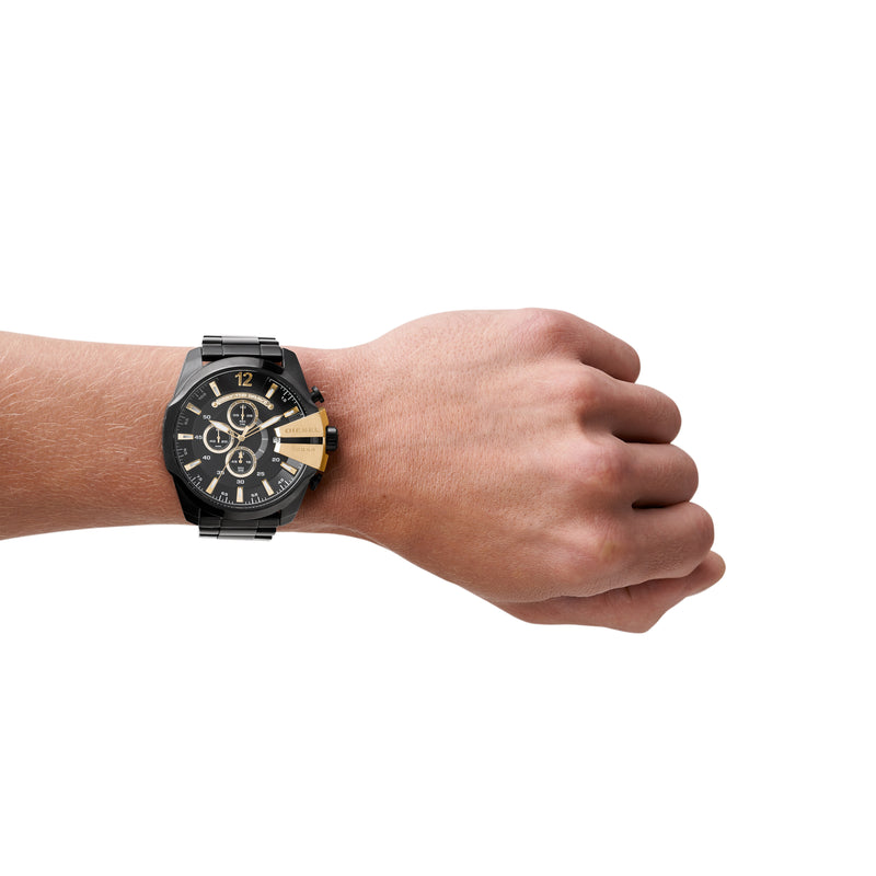 Stylish black and gold wristwatch worn on a person’s wrist.