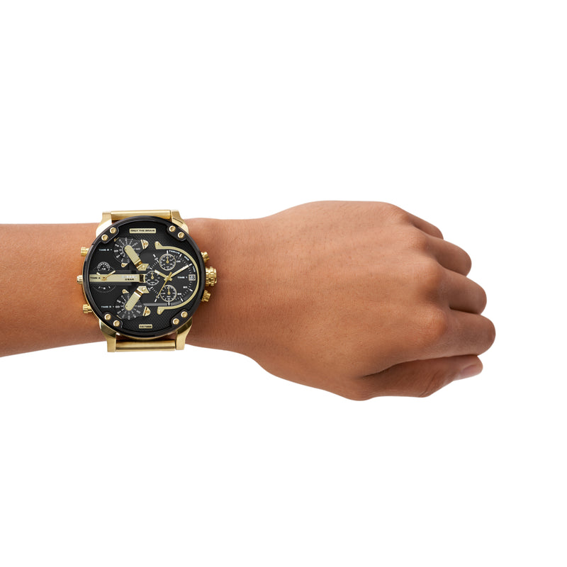 Gold and black chronograph wristwatch with multiple dials worn on a wrist.