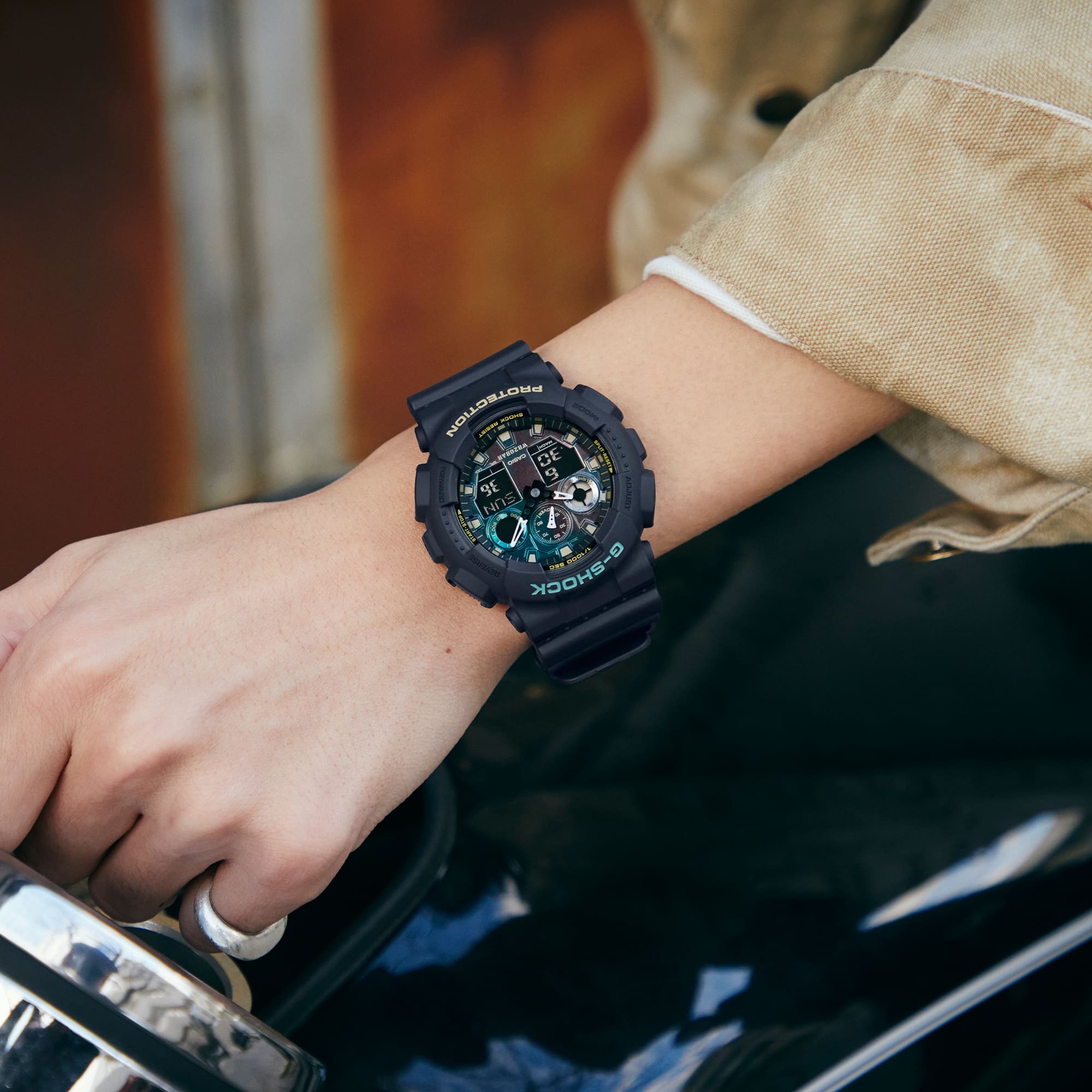 Rugged digital wristwatch with a dark blue casing and green display elements.