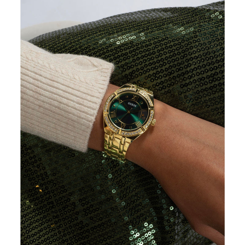 GUESS Green Cosmo Crystal Watch GW0033L8 with gold bracelet, crystal accents, and green dial, adding a chic touch to any look.