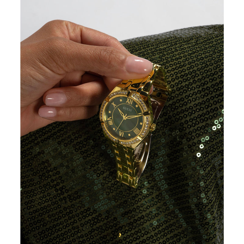 GUESS Green Cosmo Crystal Watch GW0033L8 with gold bracelet, crystal accents, and green dial, a chic statement timepiece.