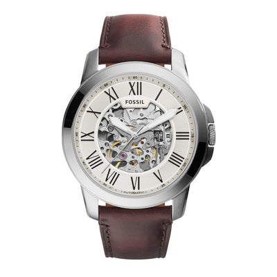 Fossil wristwatch with a brown leather strap and skeleton dial showing internal mechanisms.