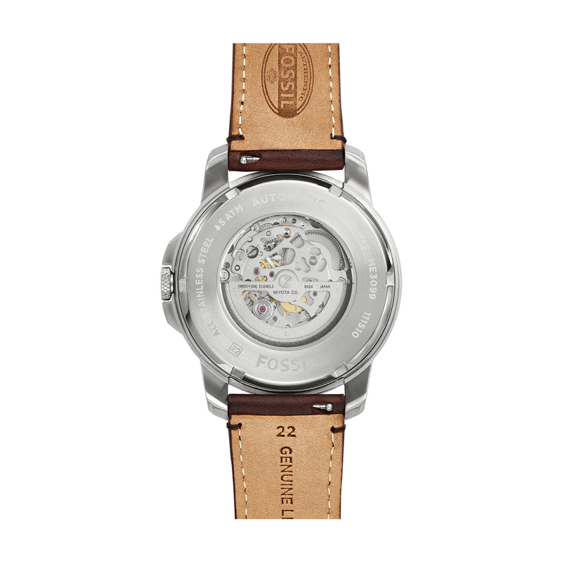 Wristwatch with a transparent back showing its mechanical movement and a tan leather strap.