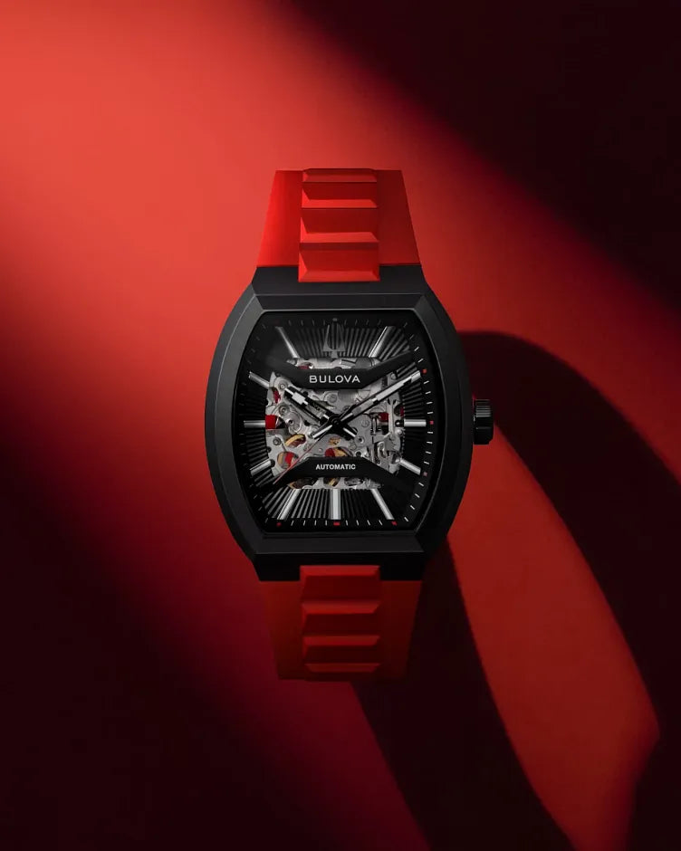 Bulova Maquina 98A341 automatic men's watch with black skeleton dial, black case and red rubber strap — caseback view
