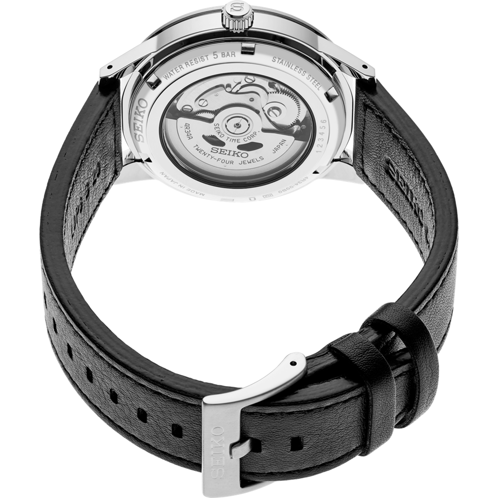 Luxury wristwatch with a visible mechanical movement through the transparent case back.