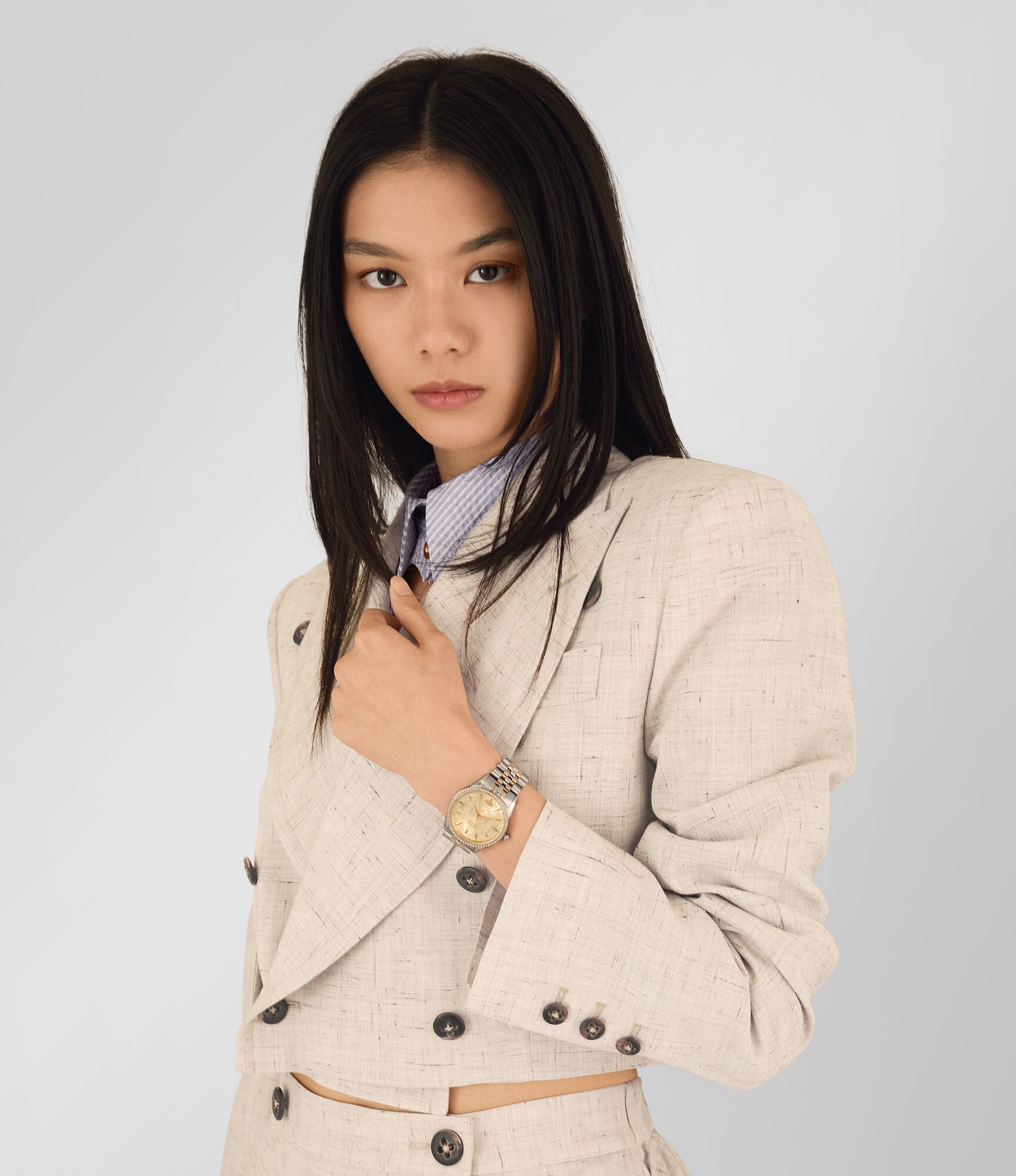 Vivienne Westwood Wallace women's watch with a gold dial and two tone stainless steel bracelet. Shown at an angle.
