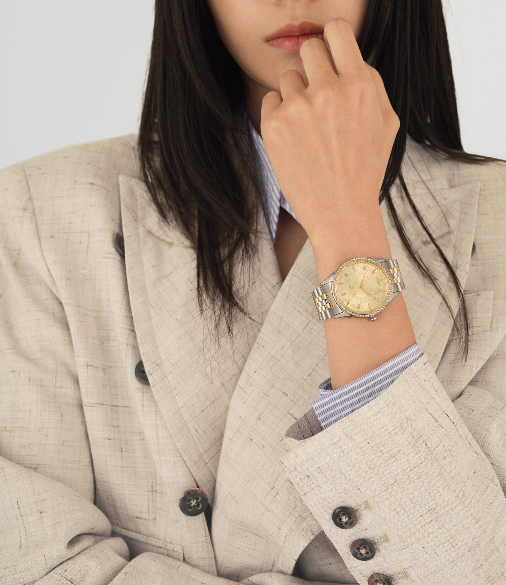 Vivienne Westwood Wallace women's watch with a gold dial and two tone stainless steel bracelet. Close-up detail view.