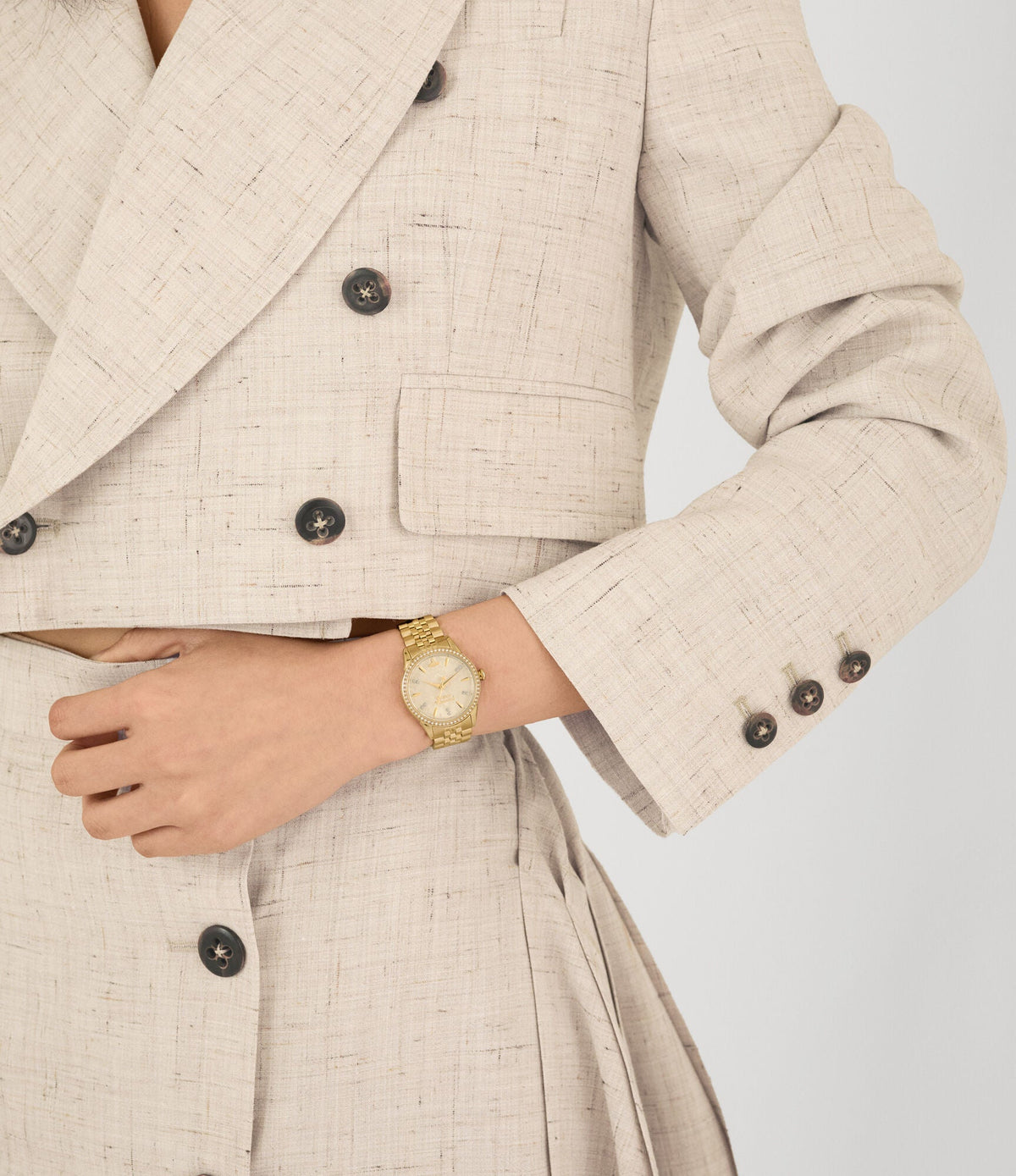 Vivienne Westwood Little Wallace women's watch with a gold dial and gold stainless steel bracelet. Close-up detail view.